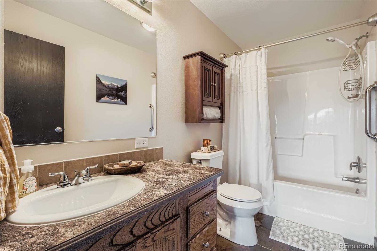 26540 Flower Circle Simla, CO 80835 - Photo 22 of 40 a bathroom with a granite countertop sink toilet and shower