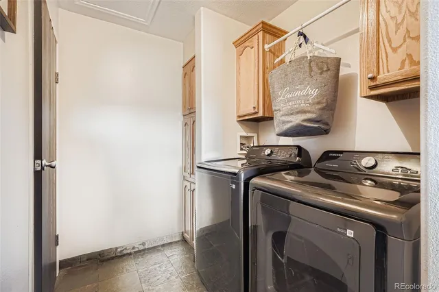 a living room with stainless steel appliances furniture a rug and a view of kitchen