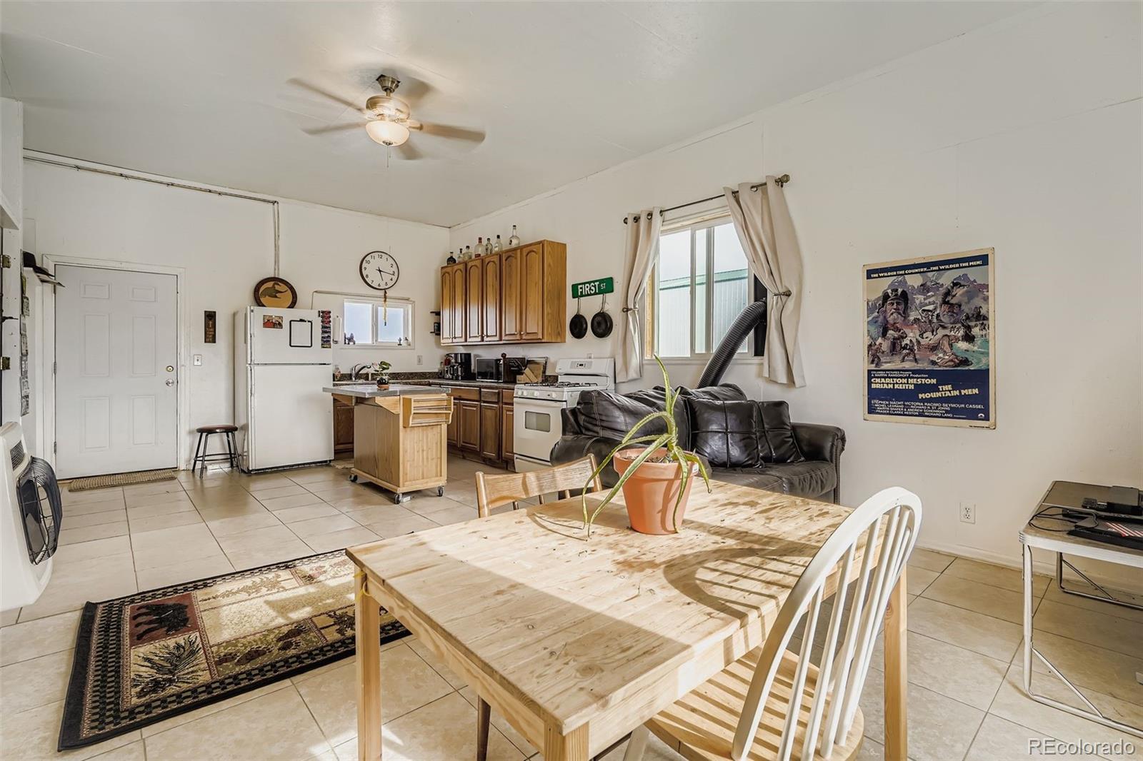 26540 Flower Circle Simla, CO 80835 - Photo 26 of 40 a living room with stainless steel appliances furniture a rug and a view of kitchen