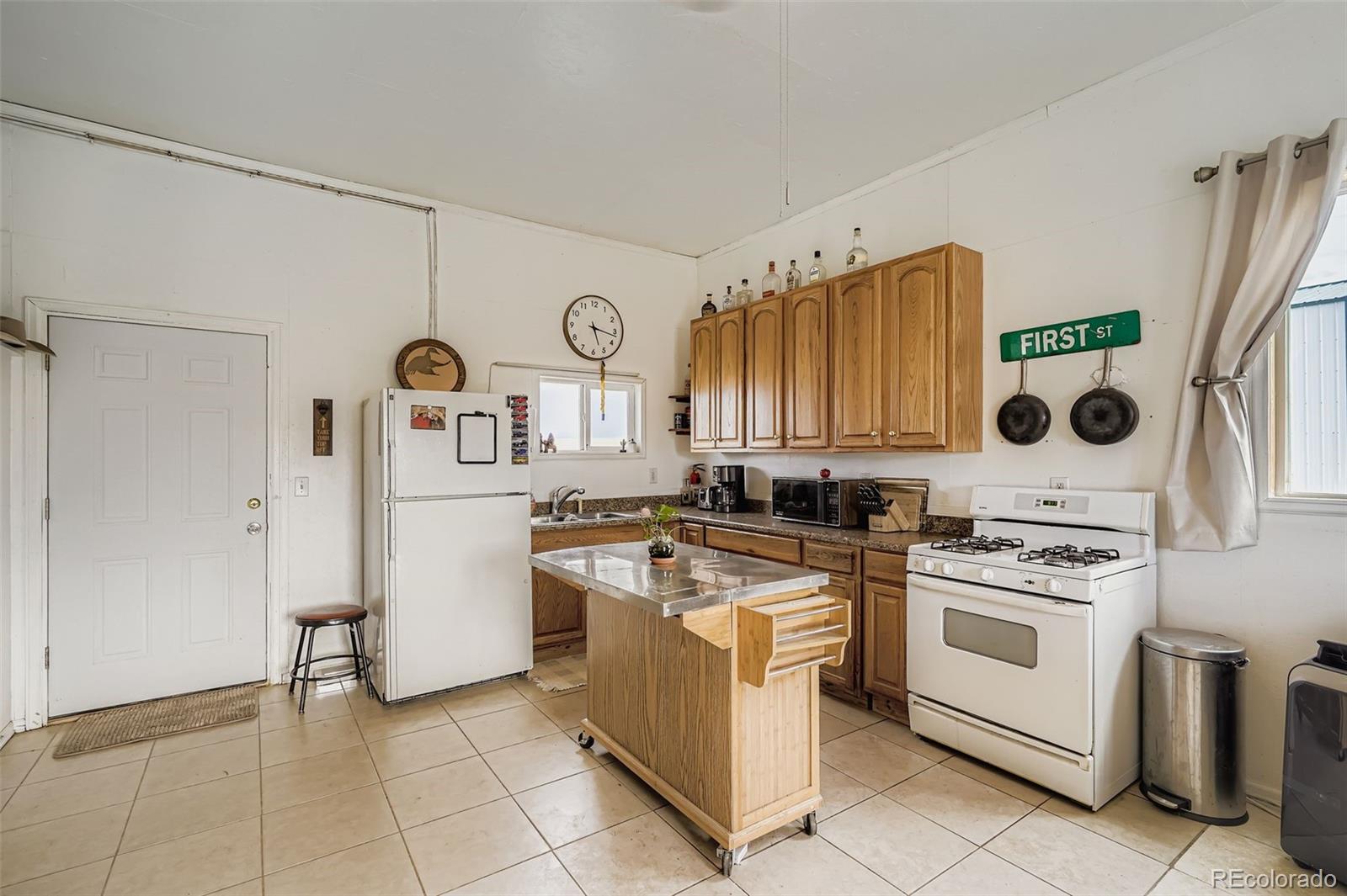 26540 Flower Circle Simla, CO 80835 - Photo 27 of 40 a kitchen with a stove top oven and refrigerator