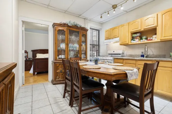 a dining room with furniture a chandelier and window