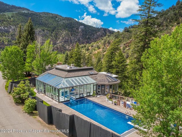 a view of a chairs and table under an umbrella in the terrace