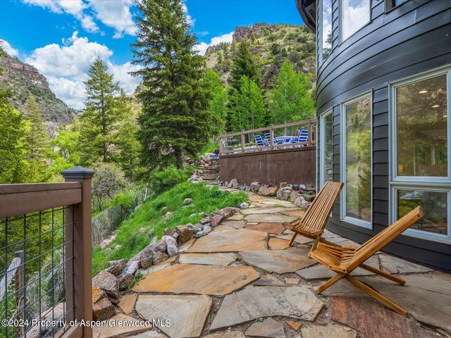 a view of a chairs and table on the wooden deck