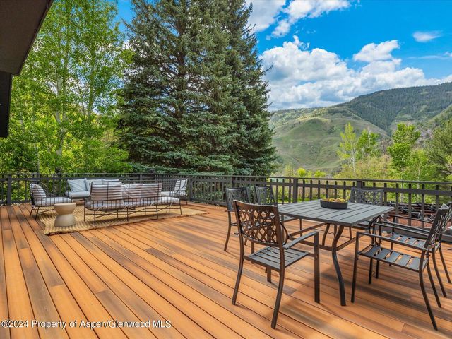 a view of house with a backyard