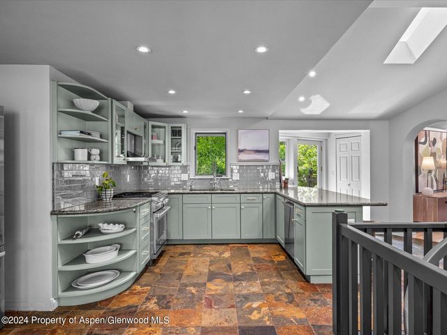 a kitchen with stainless steel appliances granite countertop a sink and cabinets