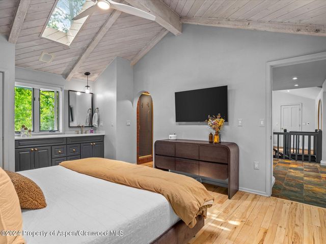 a bedroom with a bed and a large mirror