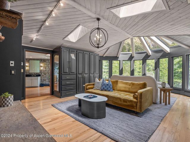 a living room with furniture a table and chairs