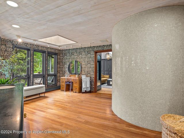 a room with wooden floor and furniture