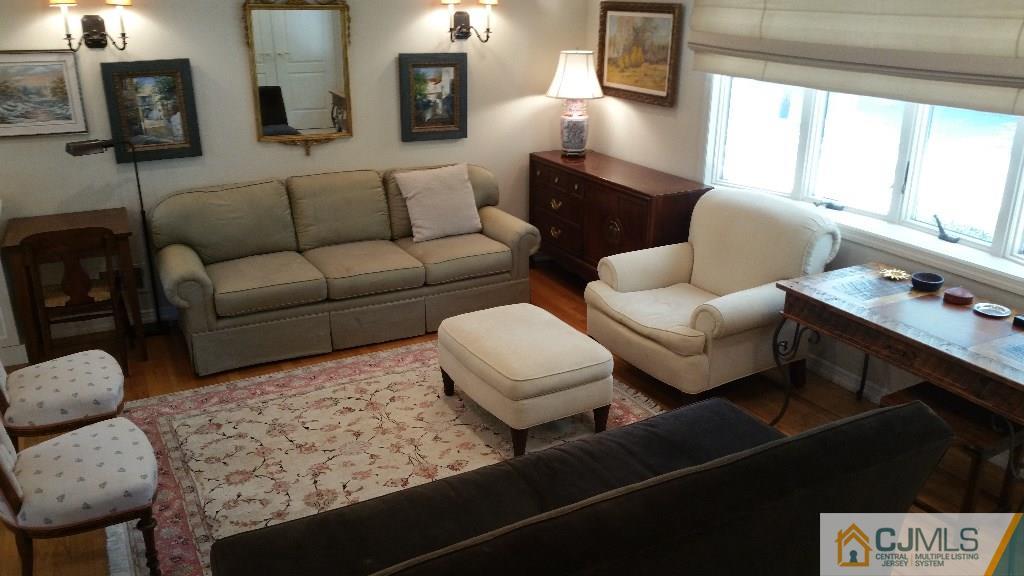 32 Peru Street Edison, NJ 08820 - Photo 9 of 25 a living room with furniture and a lamp