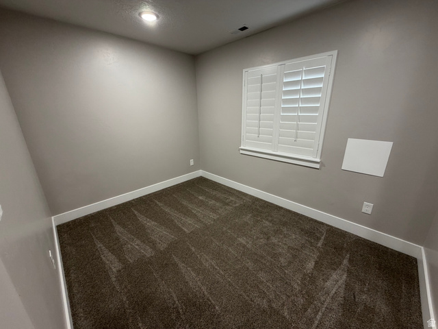 2350 North 1075 West Helper, UT 84526 - Photo 33 of 49 Unfurnished room with dark carpet and baseboards