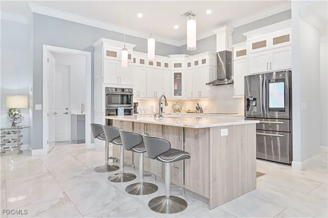 a kitchen with stainless steel appliances granite countertop a sink and a refrigerator