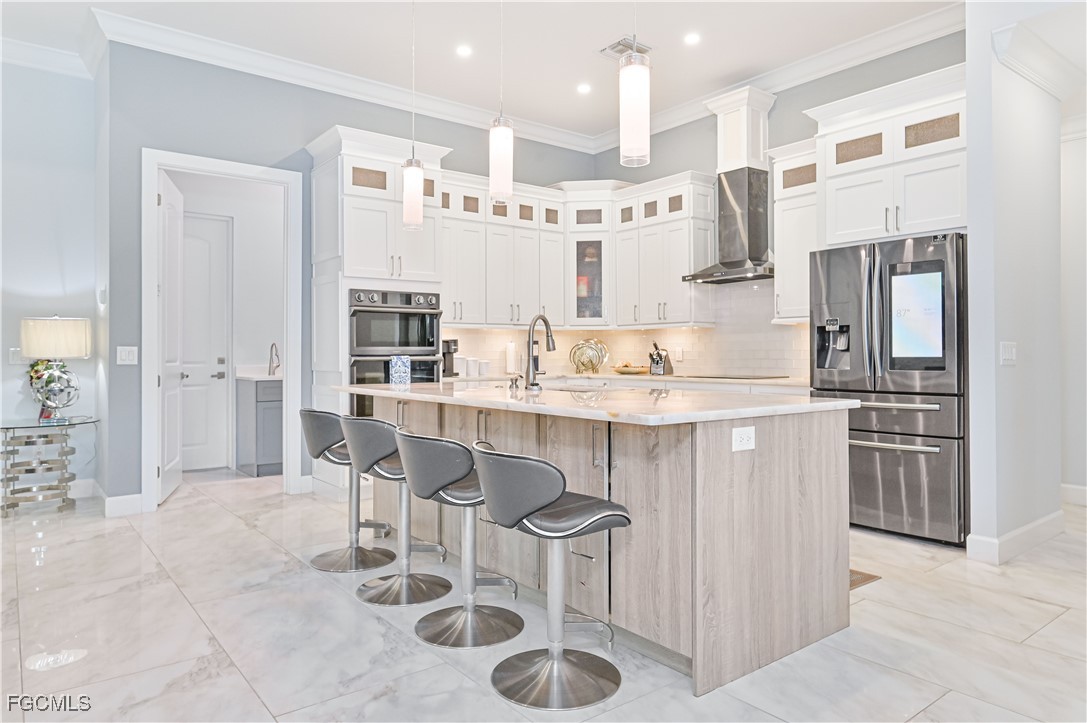 2273 Crystal Drive Fort Myers, FL 33907 - Photo 15 of 46 a kitchen with stainless steel appliances kitchen island granite countertop a refrigerator and a stove top oven