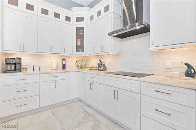 a kitchen with stainless steel appliances kitchen island a refrigerator sink and cabinets