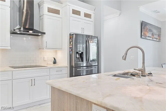 a large kitchen with kitchen island a large counter space a sink a window and stainless steel appliances