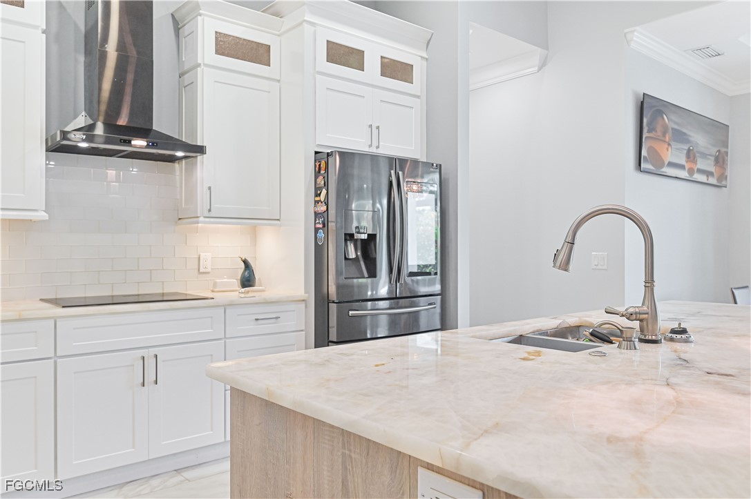 2273 Crystal Drive Fort Myers, FL 33907 - Photo 18 of 46 a kitchen with stainless steel appliances kitchen island a refrigerator sink and cabinets