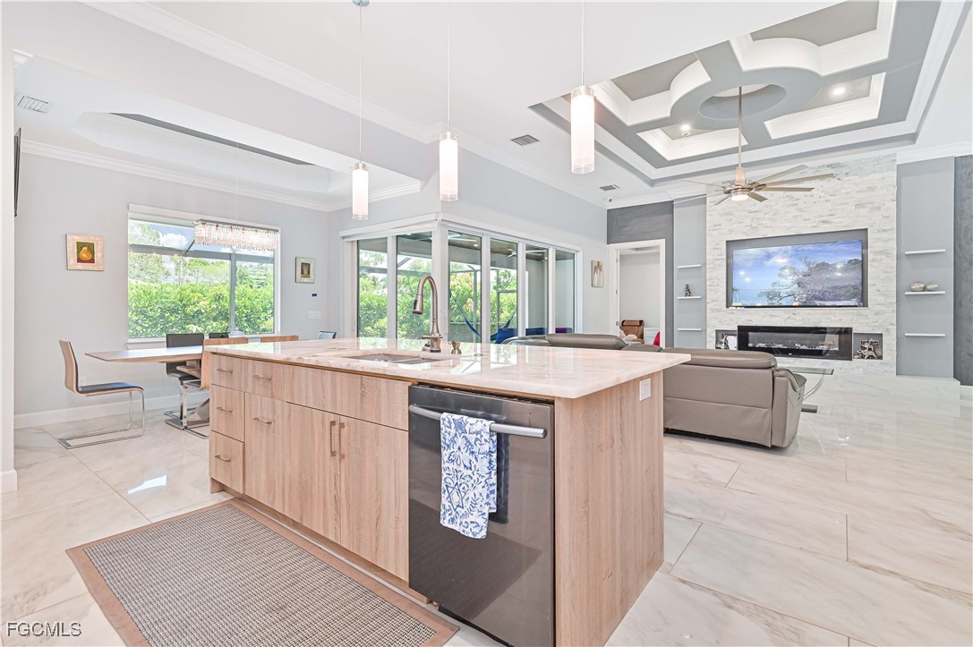 2273 Crystal Drive Fort Myers, FL 33907 - Photo 20 of 46 a large kitchen with kitchen island a large counter space a sink a window and stainless steel appliances