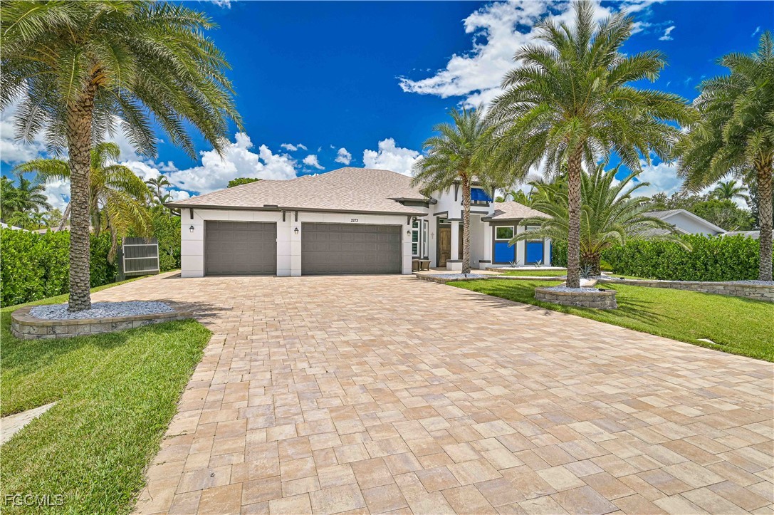 2273 Crystal Drive Fort Myers, FL 33907 - Photo 2 of 46 a view of a white house with a yard