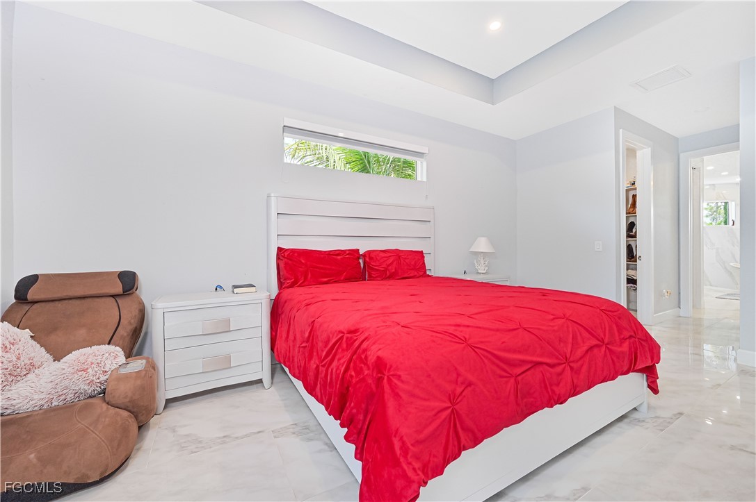 2273 Crystal Drive Fort Myers, FL 33907 - Photo 23 of 46 a bedroom with a bed and a couch