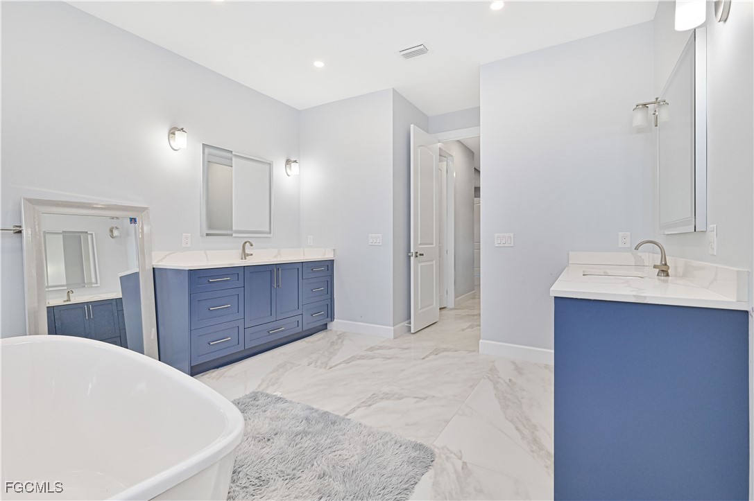2273 Crystal Drive Fort Myers, FL 33907 - Photo 26 of 46 a spacious bathroom with a tub sink and mirror