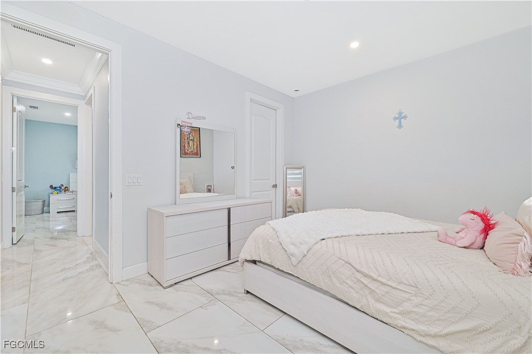 2273 Crystal Drive Fort Myers, FL 33907 - Photo 29 of 46 a bedroom with a bed and a cabinets