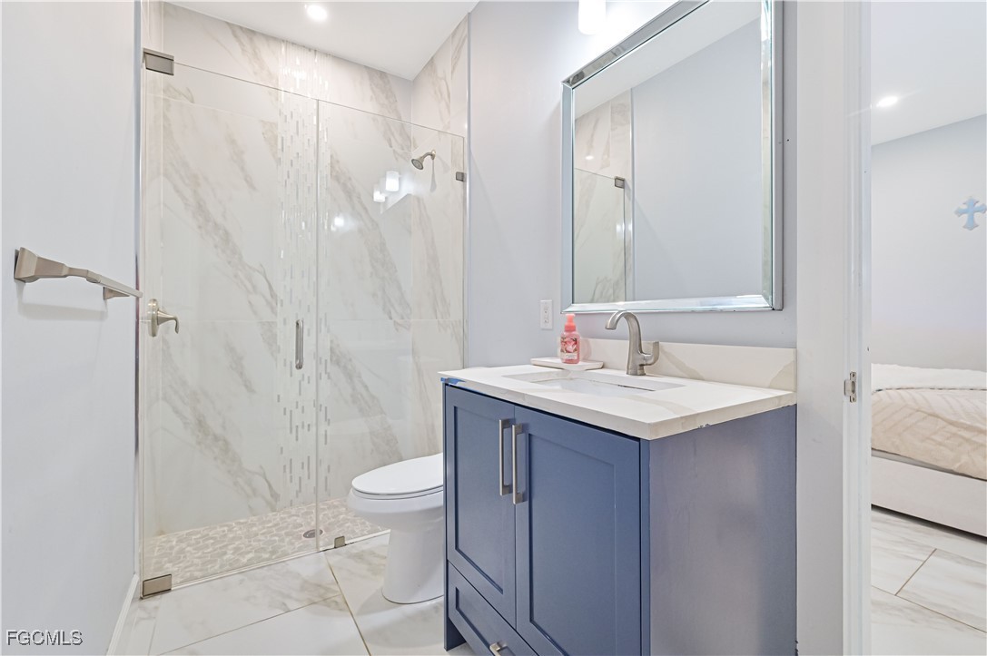2273 Crystal Drive Fort Myers, FL 33907 - Photo 30 of 46 a bathroom with a granite countertop sink toilet and shower
