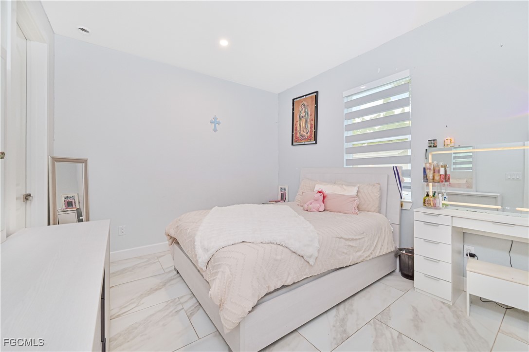 2273 Crystal Drive Fort Myers, FL 33907 - Photo 33 of 46 a bedroom with a bed and a window