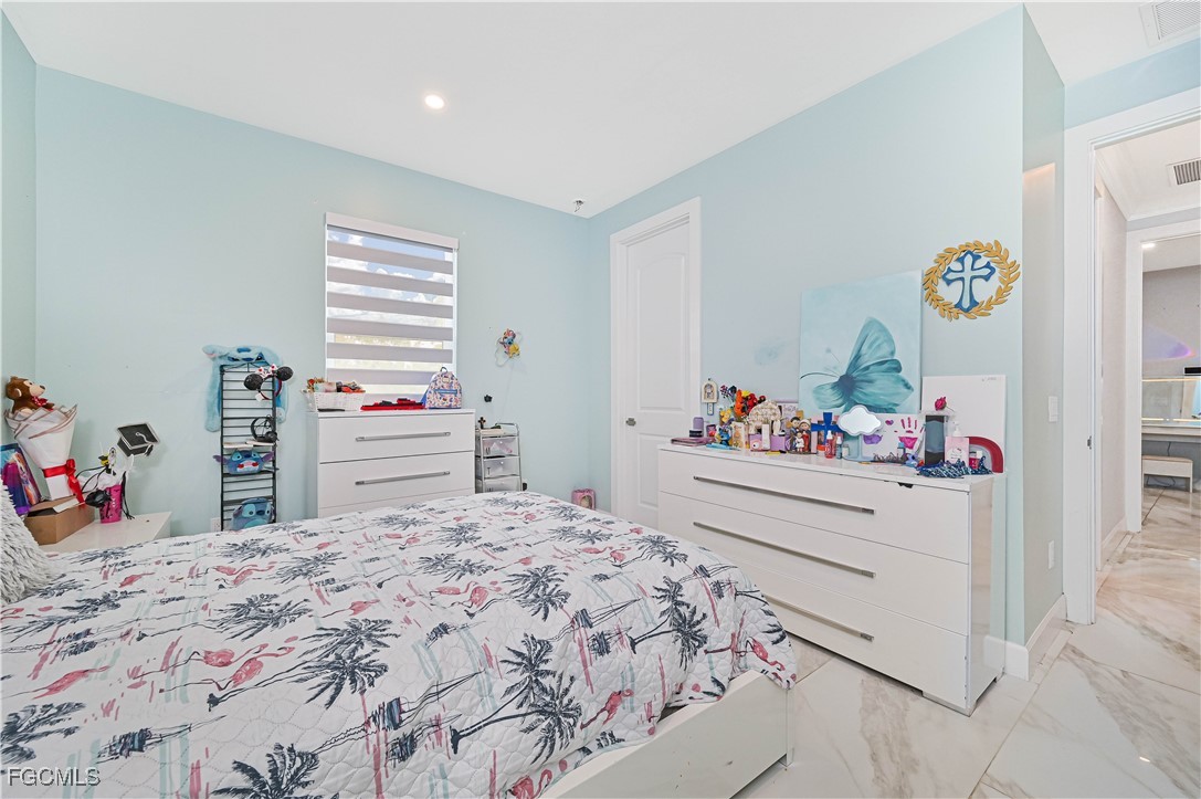 2273 Crystal Drive Fort Myers, FL 33907 - Photo 35 of 46 a bedroom with a bed and a dresser