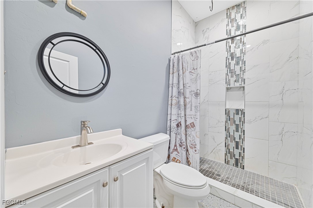 2273 Crystal Drive Fort Myers, FL 33907 - Photo 37 of 46 a bathroom with a sink a toilet and a mirror