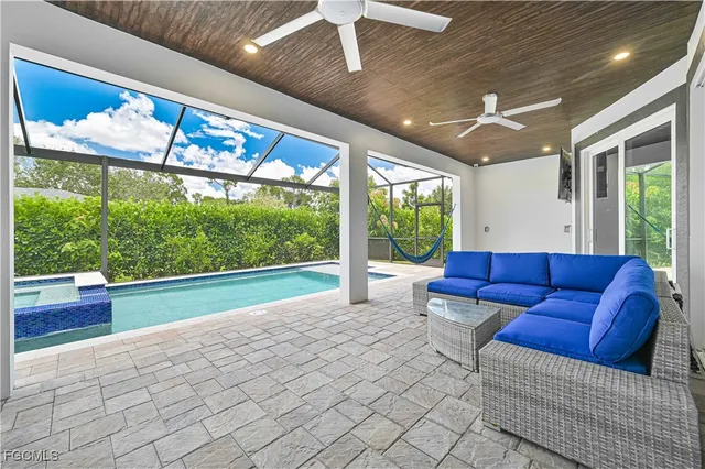 a backyard of a house with sofas fire pit and outdoor seating