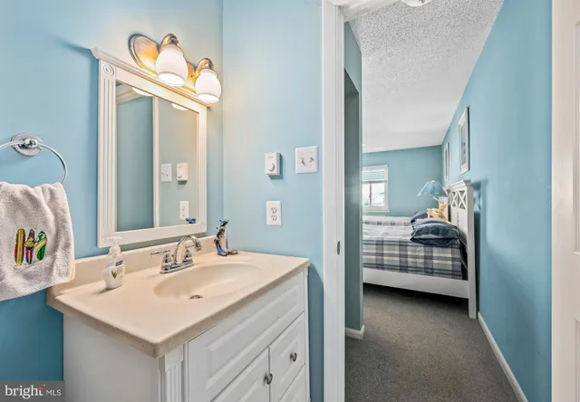 a en suite bathroom with a sink a mirror and a shower