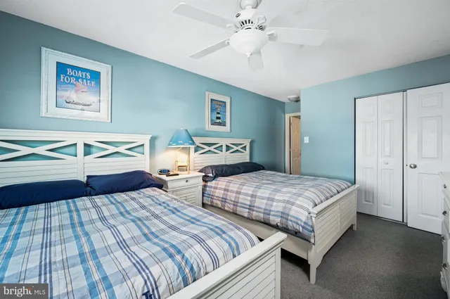 a bedroom with two beds and a chandelier