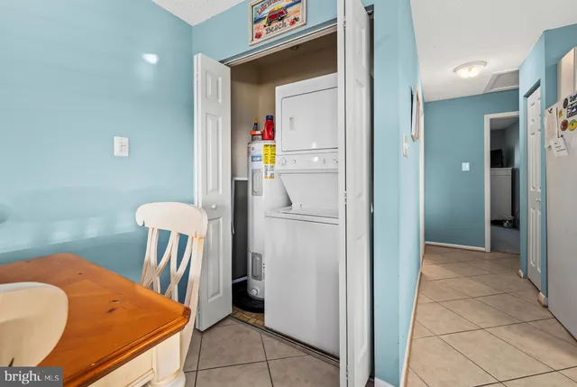 a view of kitchen with furniture and refrigerator