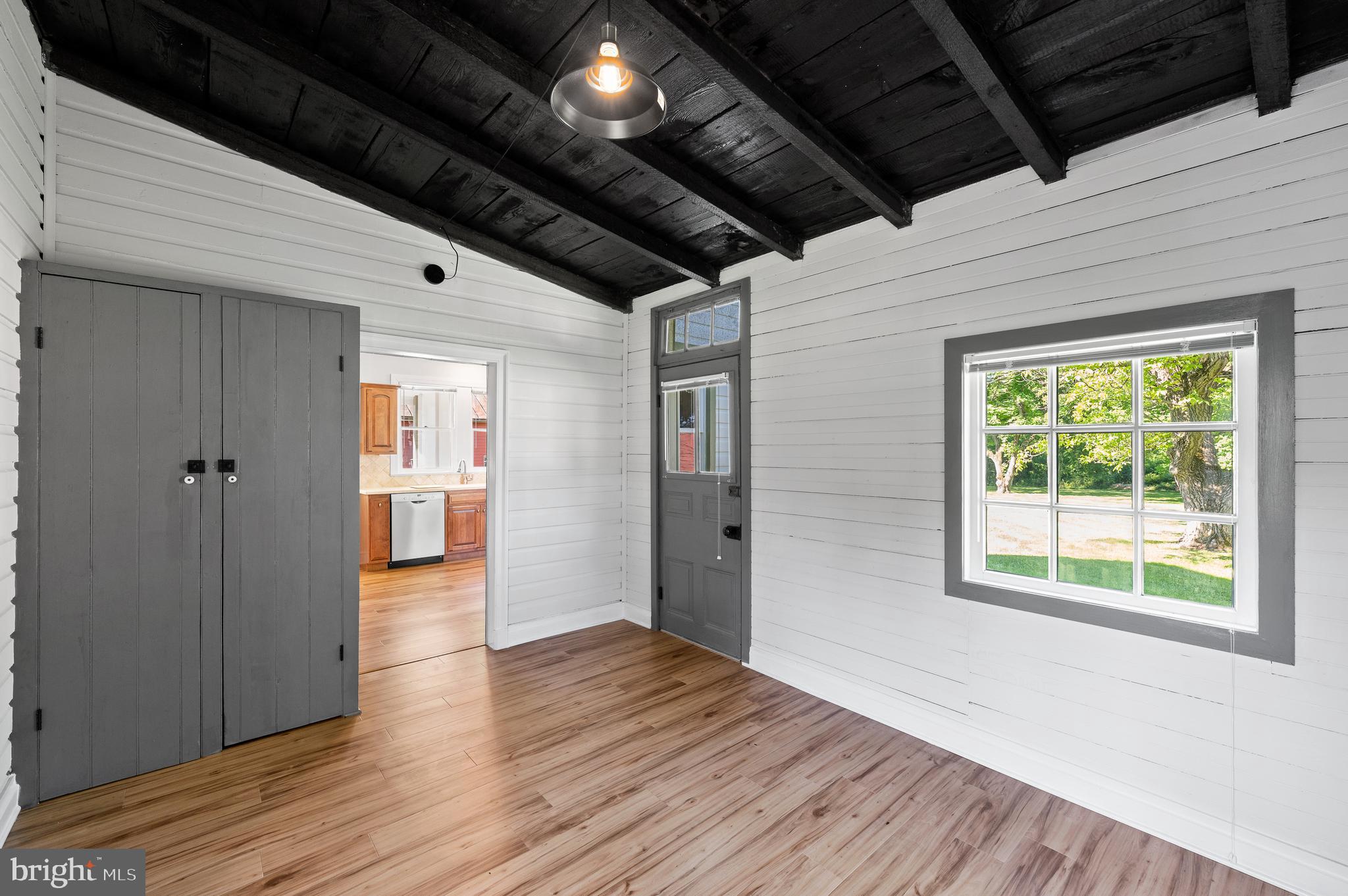 804 North Whitford Road Exton, PA 19341 - Photo 15 of 46 a view of an empty room with wooden floor and a window