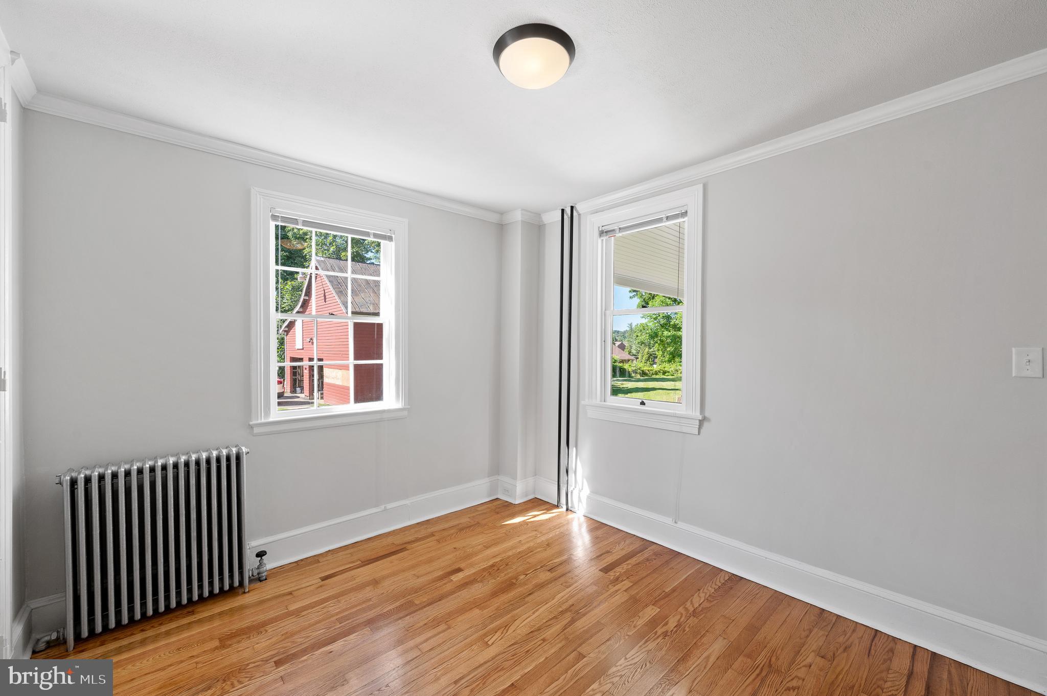 804 North Whitford Road Exton, PA 19341 - Photo 17 of 46 an empty room with wooden floor and windows
