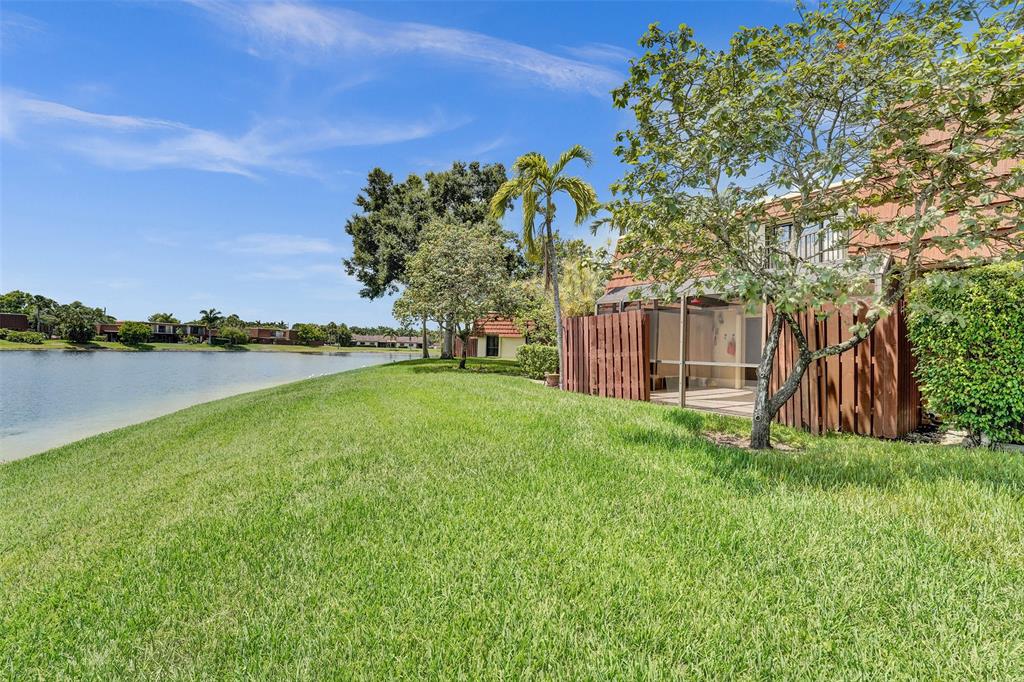 11884 Southwest 12th Place, Unit 11884 Davie, FL 33325 - Photo 1 of 48 a view of a field with sitting area and garden