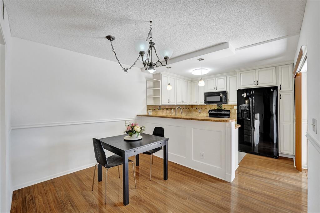 11884 Southwest 12th Place, Unit 11884 Davie, FL 33325 - Photo 12 of 48 a kitchen with stainless steel appliances kitchen island a refrigerator and a table