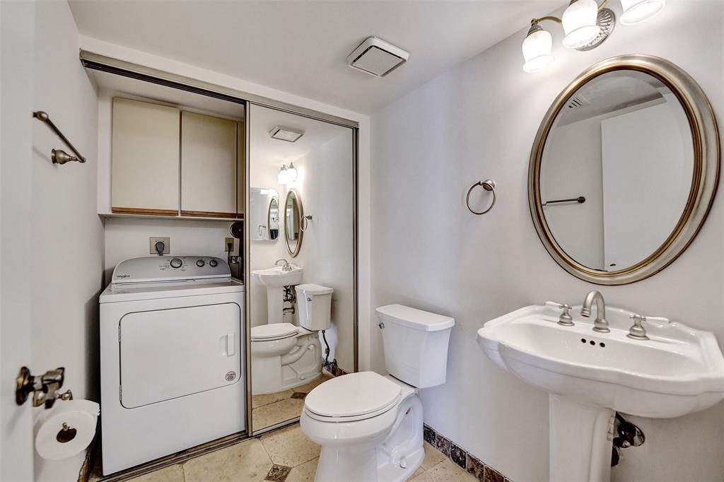 11884 Southwest 12th Place, Unit 11884 Davie, FL 33325 - Photo 16 of 48 a bathroom with a toilet sink and mirror