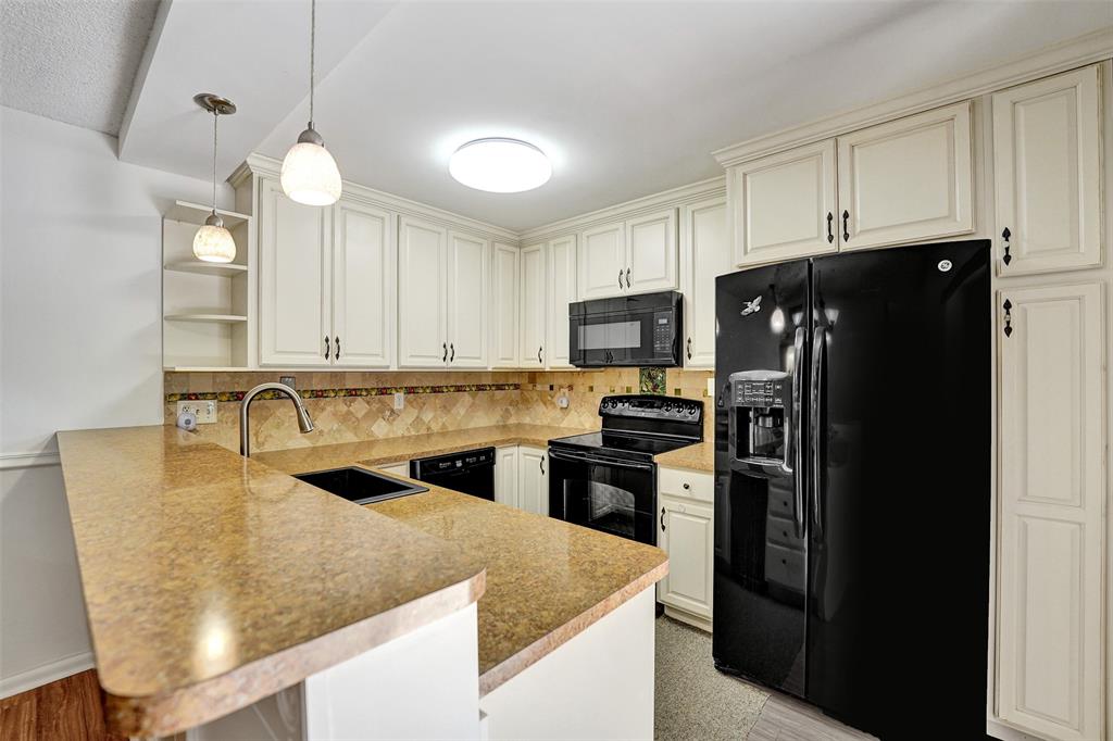 11884 Southwest 12th Place, Unit 11884 Davie, FL 33325 - Photo 18 of 48 a kitchen with granite countertop a refrigerator stove and sink
