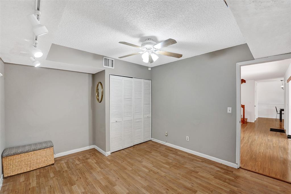 11884 Southwest 12th Place, Unit 11884 Davie, FL 33325 - Photo 21 of 48 an empty room with wooden floor and ceiling fan
