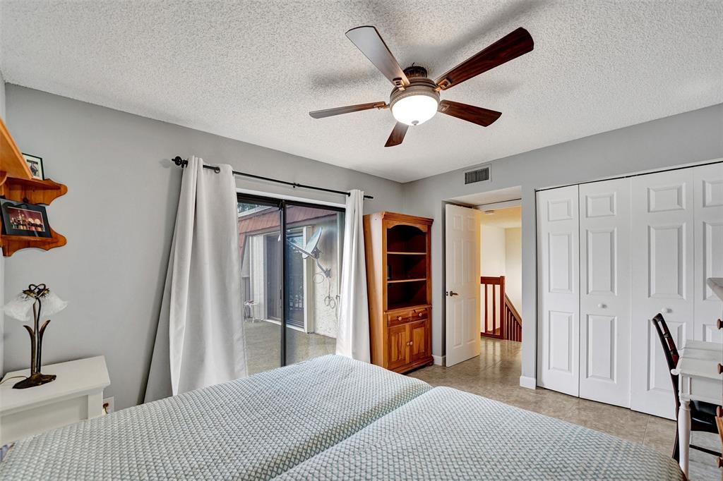 11884 Southwest 12th Place, Unit 11884 Davie, FL 33325 - Photo 28 of 48 a bedroom with a bed and a large window