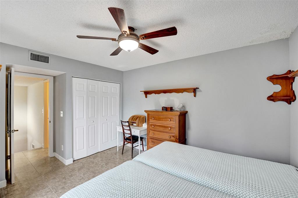 11884 Southwest 12th Place, Unit 11884 Davie, FL 33325 - Photo 29 of 48 a bedroom with furniture and a window