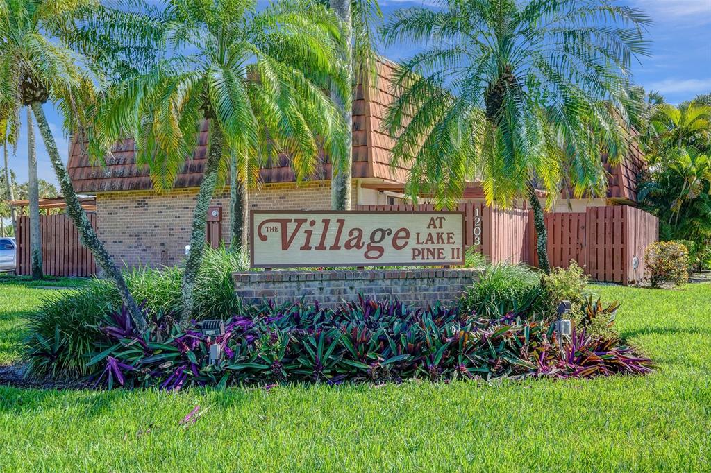 11884 Southwest 12th Place, Unit 11884 Davie, FL 33325 - Photo 42 of 48 a view of sign board with flower garden