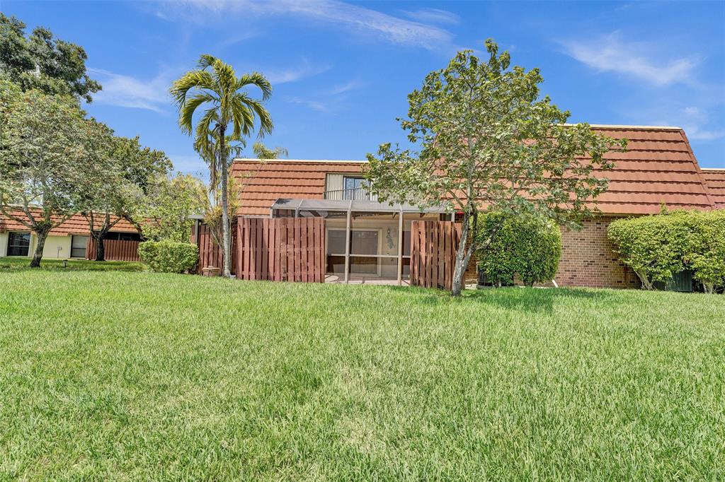 11884 Southwest 12th Place, Unit 11884 Davie, FL 33325 - Photo 6 of 48 a front view of a house with a garden