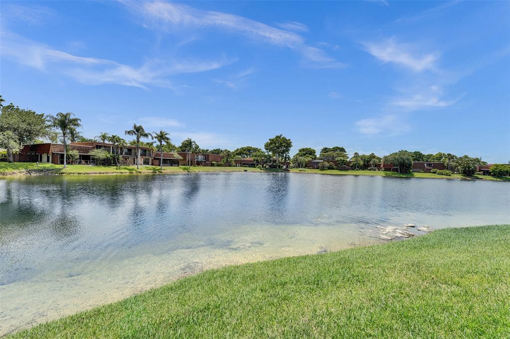 11884 Southwest 12th Place, Unit 11884 Davie, FL 33325 - Photo 7 of 48 a view of a lake with houses in the background