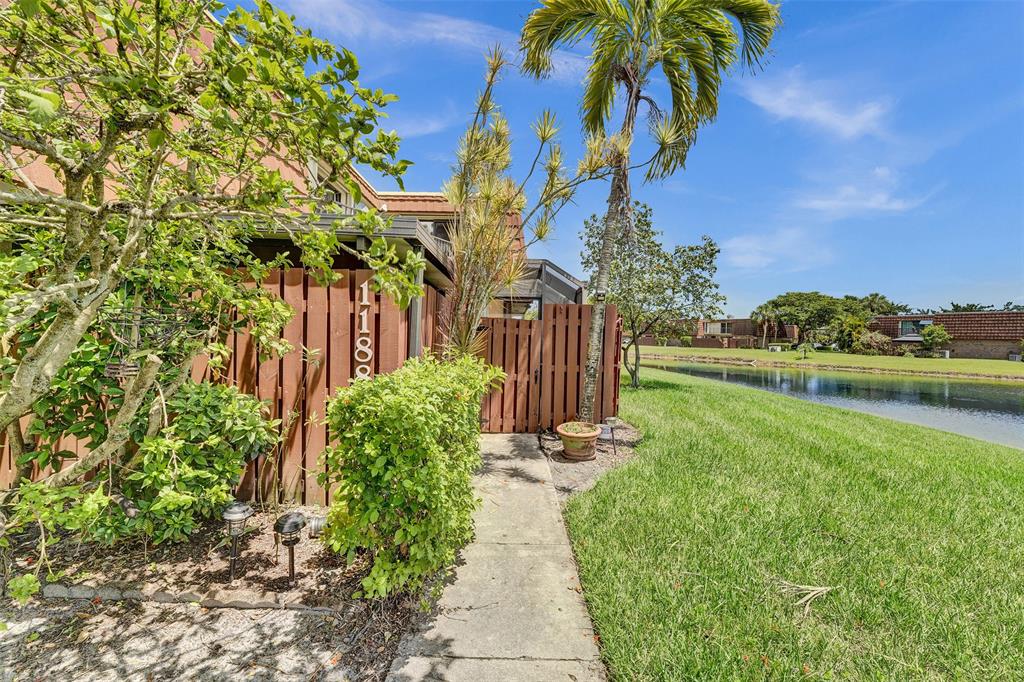 11884 Southwest 12th Place, Unit 11884 Davie, FL 33325 - Photo 8 of 48 a front view of a house with a yard