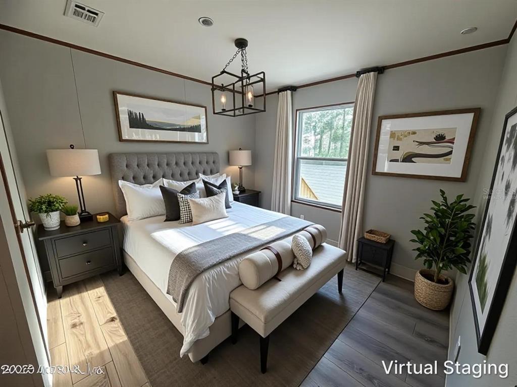 114 Nutmeg Trail Interlachen, FL 32148 - Photo 19 of 33 a bedroom with a large bed and a chandelier