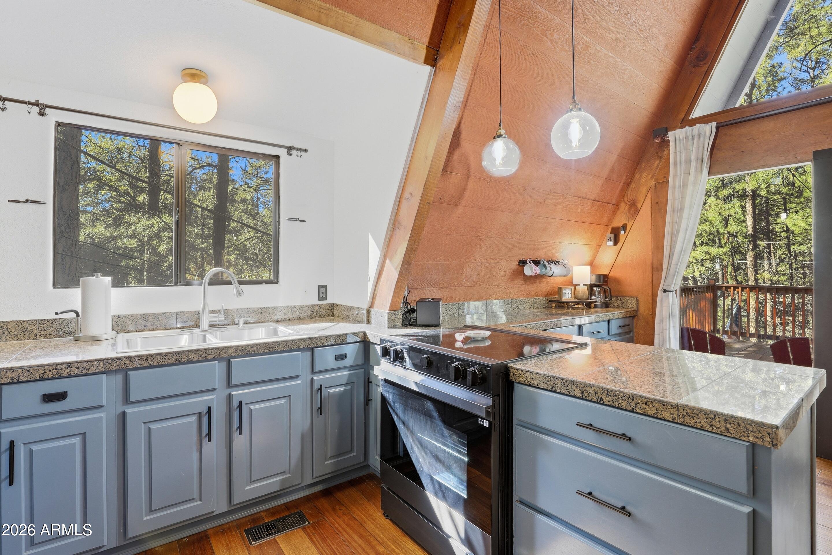 5101 Marys Way Pine, AZ 85544 - Photo 15 of 37 a kitchen with a sink stove and cabinets