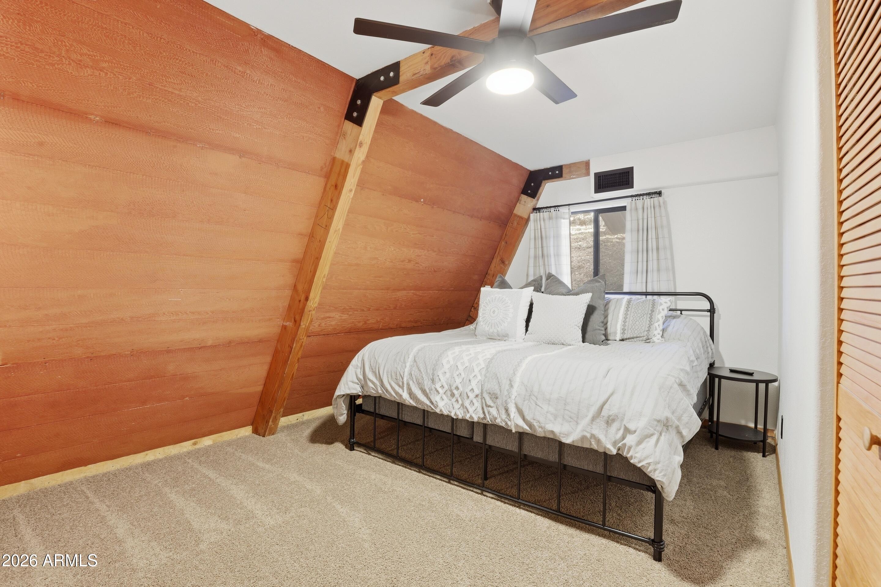5101 Marys Way Pine, AZ 85544 - Photo 21 of 37 a bed sitting in a bedroom next to a small yard
