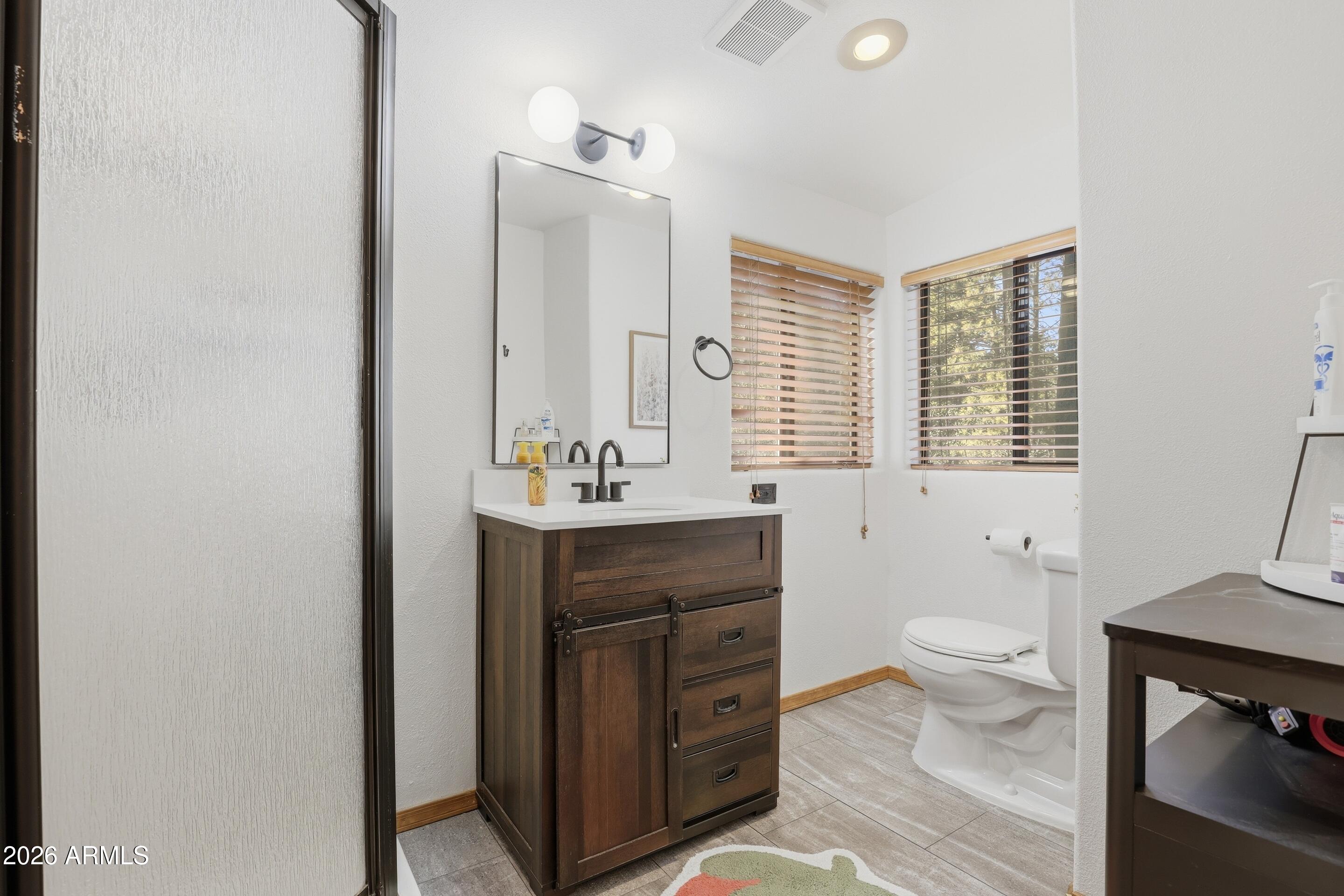 5101 Marys Way Pine, AZ 85544 - Photo 26 of 37 a bathroom with a sink a toilet and a mirror