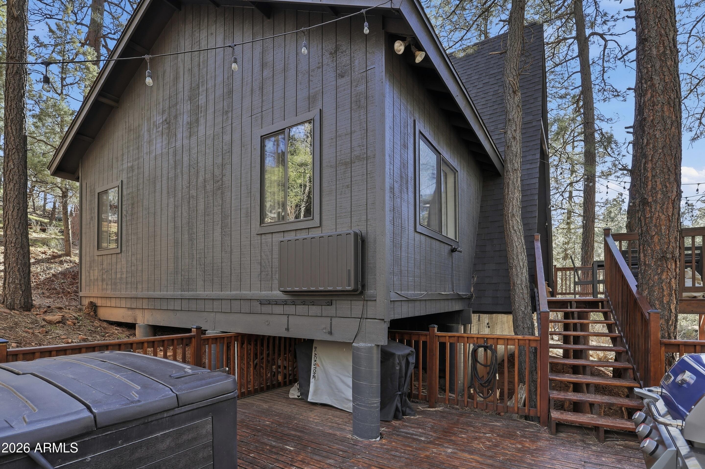 5101 Marys Way Pine, AZ 85544 - Photo 9 of 37 a backyard of a house with wooden fence and large windows